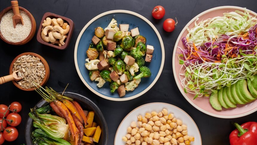 A vibrant vegan butter chicken bowl with millet, fresh greens, and colorful plant-based sides served in a modern restaurant setting.
