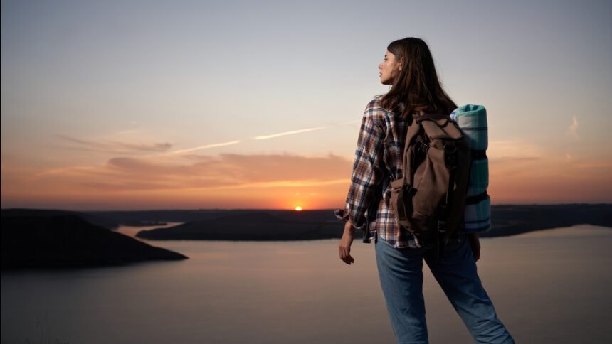 A solo woman traveller confidently exploring a scenic destination during her travel journey.