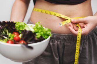woman measuring her tummy for weight loss