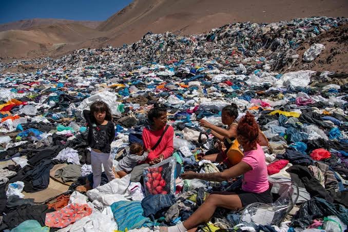 Women look for reusable clothing among the mounds of discarded items in the Atacama Desert, in Alto Hospicio, Iquique, Chile, Sept. 26, 2021. (AFP Photo)